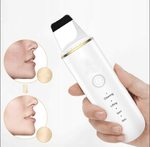 Hand holding a white ultrasonic skin scrubber for deep facial cleansing and lifting.