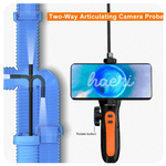 Two-way articulating camera probe showing a smartphone display and plumbing pipes for inspection.